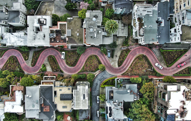 Aerial view of a zigzag road with houses besides
