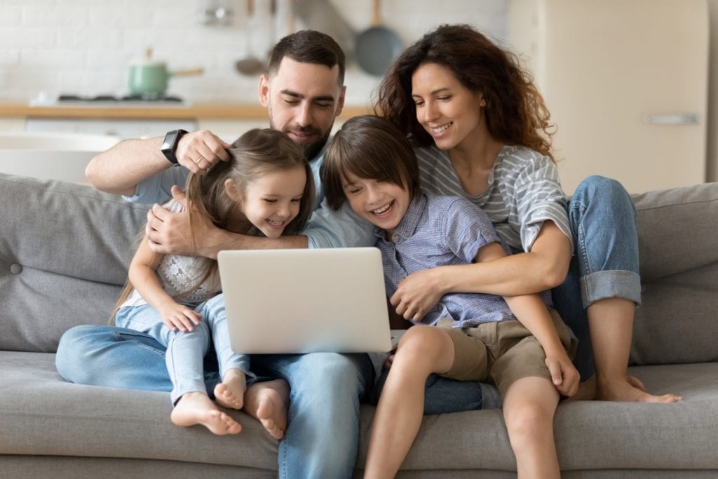 parents with their kids watching virtual class online